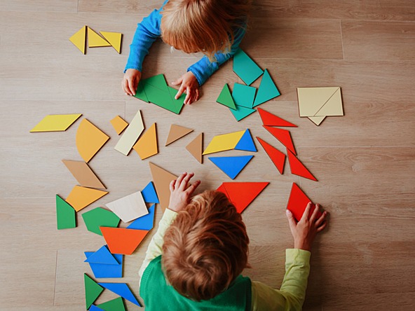 toddler playing with puzzle pieces